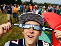 Kevin Kiser, 14 takes a look at the eclipse through the shared glasses as he and other people gather in front of the UMass Dartmouth observatory to view the partial solar eclipse that swept over the area.   [ PETER PEREIRA/THE STANDARD-TIMES/SCMG ]